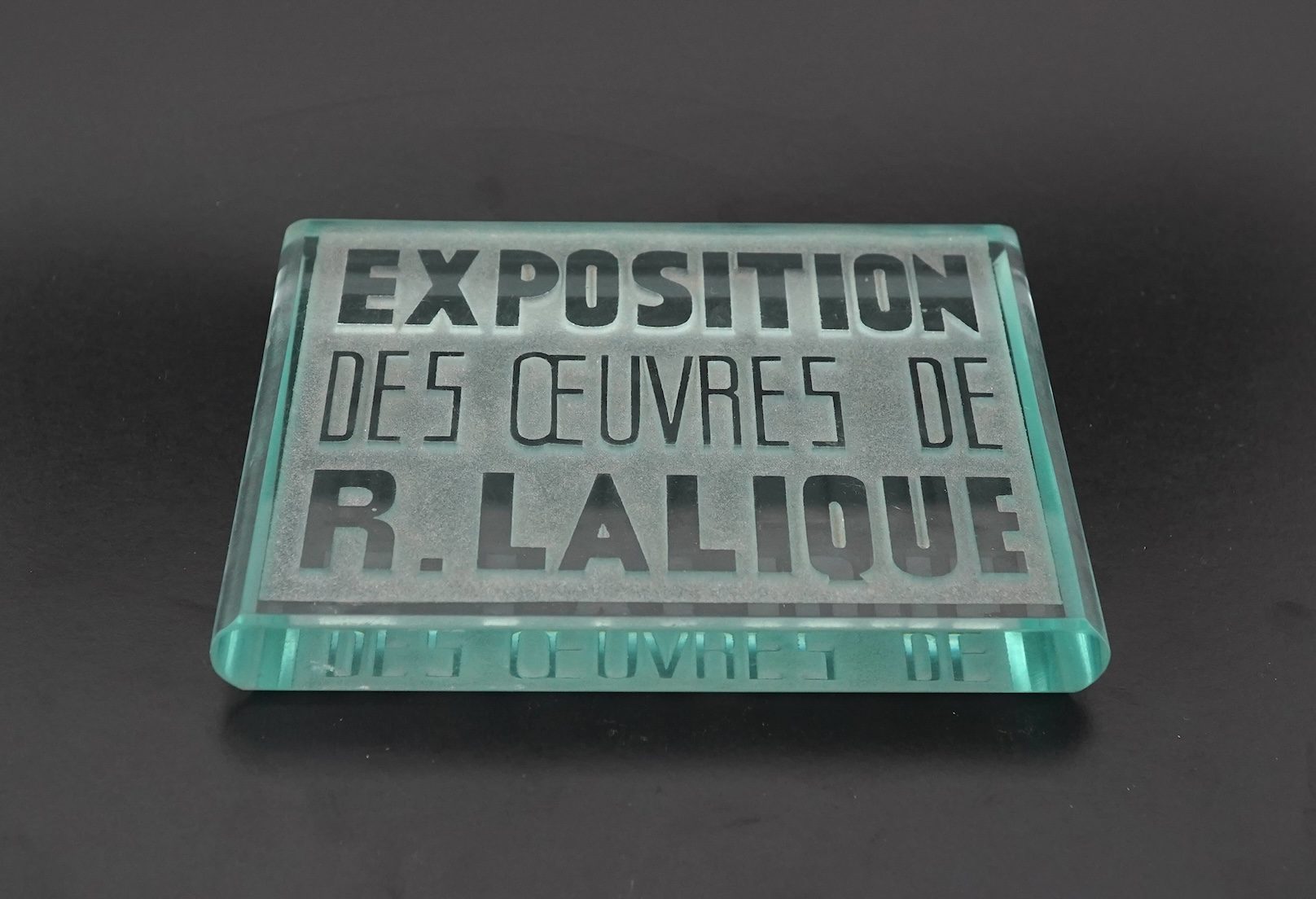 Lalique: A glass advertising plaque 'EXPOSITION DES ŒUVRES DE R.LALIQUE'